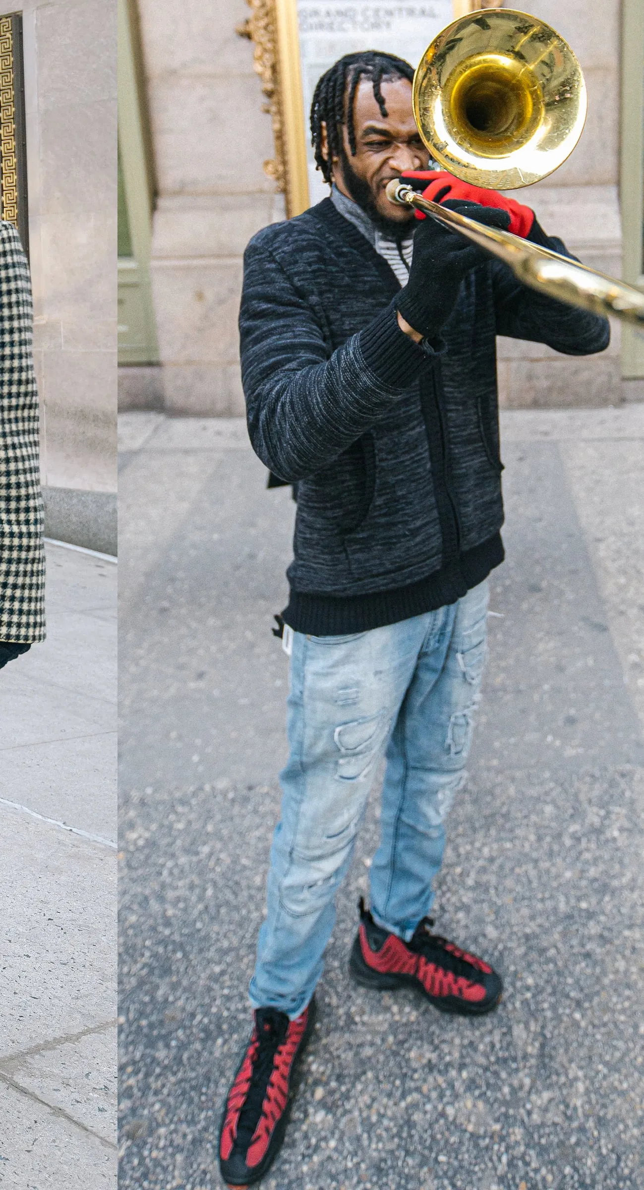 Trombonist playing outside Grand Central in red gloves